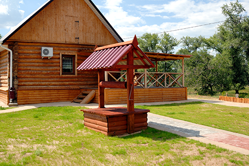 Private water well on the side of a house