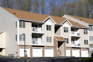 An apartment complex with garages.